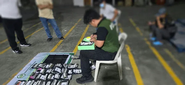 COURIER HUB SEIZURE. A Philippine Drug Enforcement Agency operative documents suspected marijuana products recovered during a K9-assisted inspection at a courier hub in Barangay San Vicente, San Pedro City, Laguna, on 30 October 2026. Authorities seized approximately 250 grams of suspected marijuana products valued at ₱30,000.